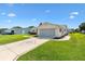 Charming home with a well-manicured lawn and long driveway to the garage at 17576 Se 96Th Ct, Summerfield, FL 34491
