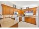 Well-maintained kitchen with granite countertops, wood cabinets, and modern appliances at 17576 Se 96Th Ct, Summerfield, FL 34491