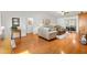 Bright and airy living room with hardwood floors and comfortable seating arrangement at 17576 Se 96Th Ct, Summerfield, FL 34491