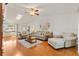 Bright living room with vaulted ceiling, skylight, hardwood floors, and comfortable seating at 17576 Se 96Th Ct, Summerfield, FL 34491