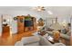Living room featuring hardwood floors, large entertainment center, and comfortable seating at 17576 Se 96Th Ct, Summerfield, FL 34491
