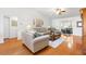 Cozy living room with hardwood floors, comfortable seating, and sliding glass doors at 17576 Se 96Th Ct, Summerfield, FL 34491