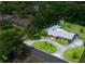 This property boasts a circular driveway and detached garage, surrounded by mature trees at 1852 Ne 39Th Ct, Ocala, FL 34470