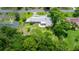 Aerial view displays the home's spacious backyard and circular driveway, blending seamlessly with the treed environment at 1852 Ne 39Th Ct, Ocala, FL 34470