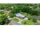 Aerial view shows the property's lush surroundings, circular driveway, and complementary landscaping at 1852 Ne 39Th Ct, Ocala, FL 34470