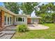 A charming backyard features a brick and siding exterior, a patio, and a well-manicured lawn at 1852 Ne 39Th Ct, Ocala, FL 34470