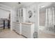 Bright bathroom with double sinks, vanity with drawers, walk-in closet, and combined bathtub with shower at 1852 Ne 39Th Ct, Ocala, FL 34470