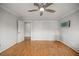 Unfurnished bedroom with wood flooring, double-door closet, and an open door at 1852 Ne 39Th Ct, Ocala, FL 34470