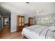 Bright bedroom featuring wood floors, large built-in dressers, a ceiling fan, and a sunny window view at 1852 Ne 39Th Ct, Ocala, FL 34470