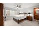 Bedroom with a large bed, ceiling fan, window, desk, and dresser at 1852 Ne 39Th Ct, Ocala, FL 34470