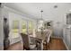 Bright dining room featuring a modern chandelier and backyard access at 1852 Ne 39Th Ct, Ocala, FL 34470