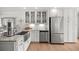 Bright kitchen featuring stainless appliances, farmhouse sink, and granite countertops at 1852 Ne 39Th Ct, Ocala, FL 34470