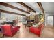 Inviting living room with exposed wood beams, brick fireplace, and hardwood flooring at 1852 Ne 39Th Ct, Ocala, FL 34470