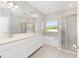 Modern bathroom featuring dual sinks, a walk-in shower, and soaking tub at 1875 Nw 44 Court Rd, Ocala, FL 34482