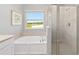 Modern bathroom with soaking tub and walk-in shower at 1875 Nw 44 Court Rd, Ocala, FL 34482