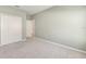 Carpeted bedroom featuring a closet with double doors, neutral walls, and an open doorway to another room at 1875 Nw 44 Court Rd, Ocala, FL 34482