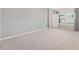 Bedroom with neutral colors, carpet and a view to the outside at 1875 Nw 44 Court Rd, Ocala, FL 34482