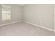 Bright bedroom with neutral carpet, a window with a light blue cornice, and light gray walls at 1875 Nw 44 Court Rd, Ocala, FL 34482