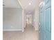 Open foyer with wood-look tile flooring leading into a bright, spacious interior, with a view down a long hallway at 1875 Nw 44 Court Rd, Ocala, FL 34482