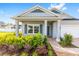 Welcoming home exterior featuring a brick pathway, lovely landscaping, and an inviting front porch with white columns at 1875 Nw 44 Court Rd, Ocala, FL 34482