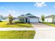 Beautiful single-story home with landscaped yard, paved driveway, and a two-car garage at 1875 Nw 44 Court Rd, Ocala, FL 34482