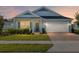 Charming single-story home with a well-manicured lawn and a brick driveway leading to an attached two-car garage at 1875 Nw 44 Court Rd, Ocala, FL 34482