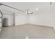 Spacious garage with epoxy flooring, white walls, and an overhead door at 1875 Nw 44 Court Rd, Ocala, FL 34482
