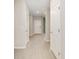 Bright hallway with neutral walls, wood-look tile floors, and white doors leading to various rooms in the house at 1875 Nw 44 Court Rd, Ocala, FL 34482