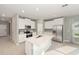 Bright kitchen featuring white cabinets, stainless steel appliances, a center island, and wood-look tile flooring at 1875 Nw 44 Court Rd, Ocala, FL 34482