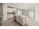Modern kitchen with a large center island, stainless steel appliances, and a view into the adjacent living area at 1875 Nw 44 Court Rd, Ocala, FL 34482