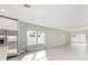 Open-concept living room with wood floors, bright windows and view to the neighborhood at 1875 Nw 44 Court Rd, Ocala, FL 34482