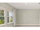 Light-filled room with gray wood tile flooring, large windows, and modern drapery at 1875 Nw 44 Court Rd, Ocala, FL 34482