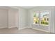 Light-filled room featuring wood look ceramic flooring and multiple windows with light filtering drapes at 1875 Nw 44 Court Rd, Ocala, FL 34482