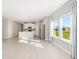 Spacious living room next to the kitchen, features abundant sunlight and wood flooring at 1875 Nw 44 Court Rd, Ocala, FL 34482
