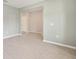 Light gray room with wood look ceramic flooring, light walls, and an opening to another room at 1875 Nw 44 Court Rd, Ocala, FL 34482