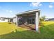 Backyard view of the screened in porch with ceiling fan and brick pavers at 1875 Nw 44 Court Rd, Ocala, FL 34482