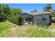 A peaceful backyard featuring a screened-in pool area, lush greenery, and privacy fencing for relaxation and enjoyment at 2010 Se 25Th St, Ocala, FL 34471