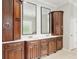 Bathroom featuring dual vanities, white countertops, decorative mirrors, and tile floors at 2010 Se 25Th St, Ocala, FL 34471
