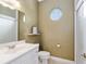 Cozy powder room with a decorative mirror, neutral tones, and classic fixtures at 2010 Se 25Th St, Ocala, FL 34471