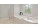 Clean bathroom with a soaking tub under a window with a shower to the left at 2010 Se 25Th St, Ocala, FL 34471