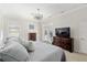 Bright bedroom with a patio door, features a ceiling fan, closet door, and a large dresser at 2010 Se 25Th St, Ocala, FL 34471