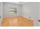 Bright bedroom boasts hardwood floors and a large window for natural light at 2010 Se 25Th St, Ocala, FL 34471