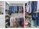 Walk-in closet with an array of hanging clothes, shoes, and accessories at 2010 Se 25Th St, Ocala, FL 34471