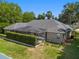Large backyard with a screened-in pool, lush landscaping, and a privacy fence, offering a serene outdoor retreat at 2010 Se 25Th St, Ocala, FL 34471