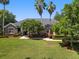 Well-manicured front yard with lush landscaping, mature trees, and a charming walkway leading to the front entrance of the home at 2010 Se 25Th St, Ocala, FL 34471