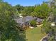 Lush landscaping and mature trees surround this beautiful home with a well-manicured lawn, creating a serene curb appeal at 2010 Se 25Th St, Ocala, FL 34471