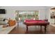 Pool table in a bright, airy game room with sliding glass doors offering views of the outdoor living area at 2010 Se 25Th St, Ocala, FL 34471