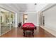 Elegant game room showcasing a high-quality pool table and seamless transition to outdoor living through sliding glass doors at 2010 Se 25Th St, Ocala, FL 34471