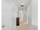 Well-lit hallway featuring neutral paint, carpet floors, and closet door at 2010 Se 25Th St, Ocala, FL 34471