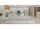 A beautifully appointed kitchen featuring white cabinets, granite countertops, stainless steel appliances and eat-in breakfast bar at 2010 Se 25Th St, Ocala, FL 34471